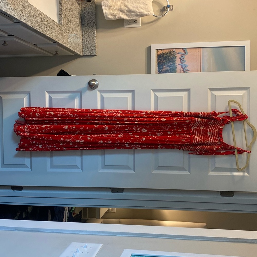 Free People red jumpsuit with white flower pattern